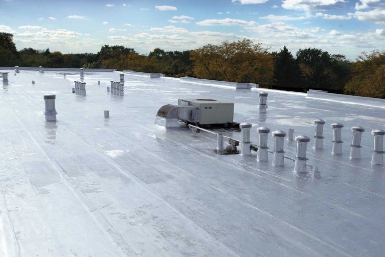 Flat commercial roof in Auckland with white TPO membrane roofing, rooftop HVAC unit and vent stacks