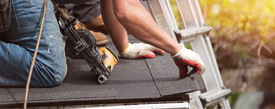 Roofing technician installing new commercial roofing material