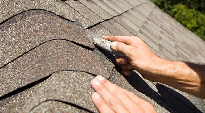 Roofer carrying out roof repairs and maintenance